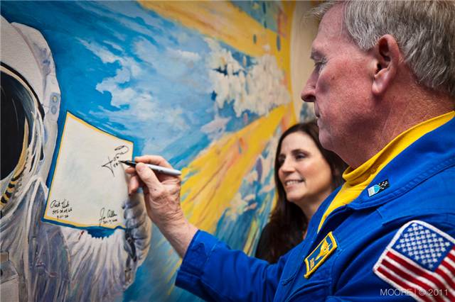 Jon McBride signing the CLC wall