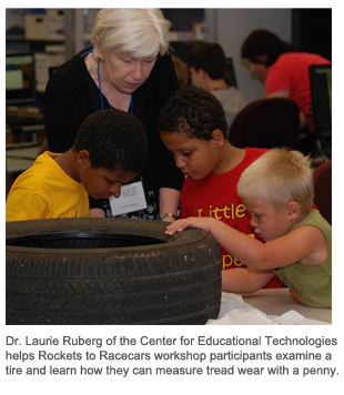 Dr. Laurie Ruberg of the Center for Educational Technologies helps Rockets to Racecars workshop participants examine a tire and learn how they can measure tread wear with a penny.