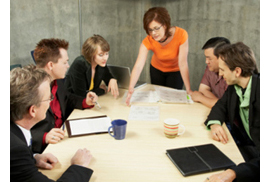 Image of some people attending an office meeting.