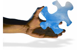 Image of a hand holding a puzzle piece.